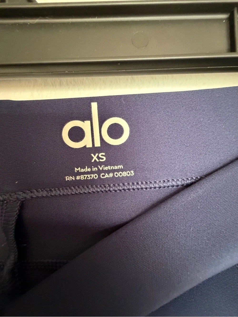 Alo Yoga High-Waist Airlift 4 Pocket Utility Leggings in a dark navy blue color.